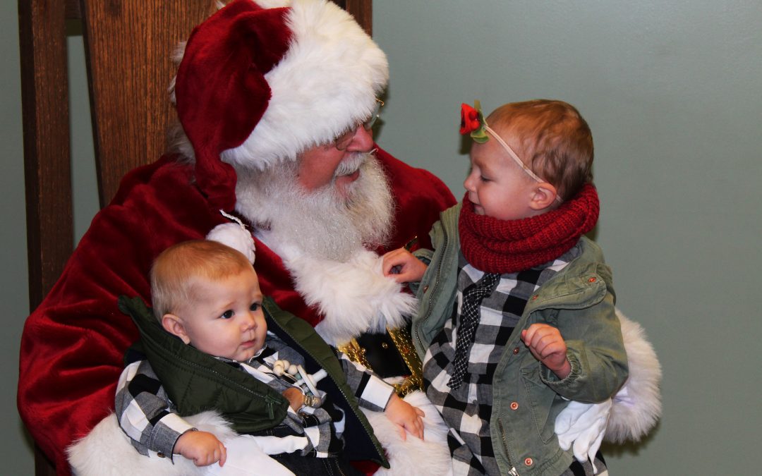 Santa talking to young babies